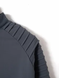 Detailed macro view of the pleated shoulder and sleeve stitching on a men's polo shirt