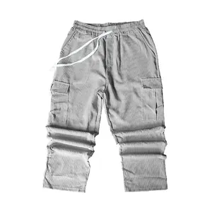 Macro view showing the thick corduroy texture and drawstring of these grey cargo pants.