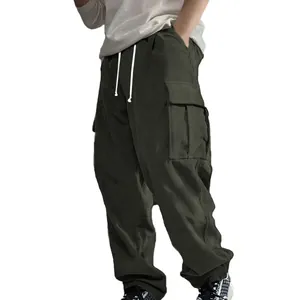 Close-up detail of dark olive corduroy cargo pants with side flap pockets and drawstrings