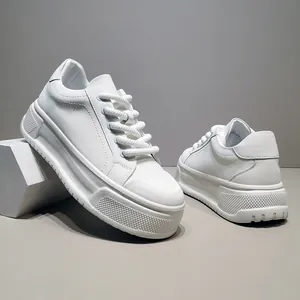 Λεπτομερής πλάγια όψη λευκών ανδρικών sneakers με χοντρή σόλα και πλεκτά κορδόνια.