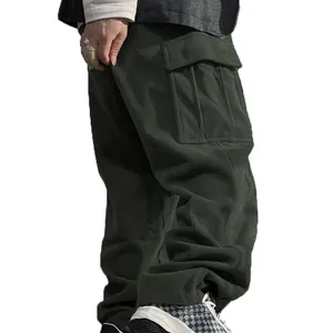Detailed side view of men's olive green corduroy cargo pants featuring large side pockets