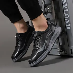 Stylish black leather sneakers for men with gray striped details and a thick sole.