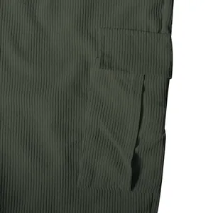 Macro close-up detail of the olive green corduroy cargo pant pocket and fabric texture
