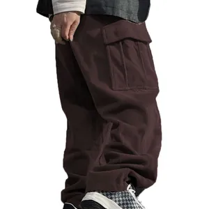 Detailed view of men's brown corduroy cargo pants featuring a large side pocket