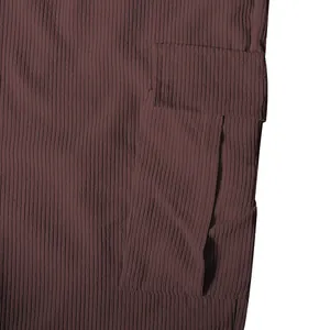 Close-up of cargo pocket and ribbed fabric texture on brown corduroy pants.