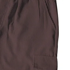 Macro close-up view of the ribbed corduroy fabric and pocket detail on brown cargo pants.