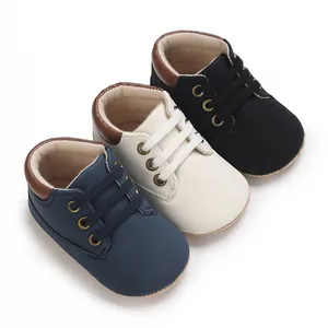 Close-up of three pairs of soft sole baby walking shoes in blue white and black