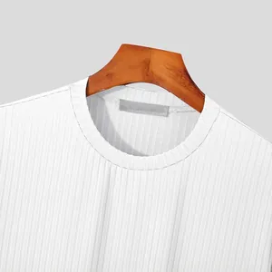 Macro view showing the fine ribbed texture and crew neck of a white knit T-shirt.