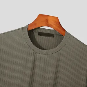 Close-up detail of a men's olive green ribbed knit T-shirt with a round neckline