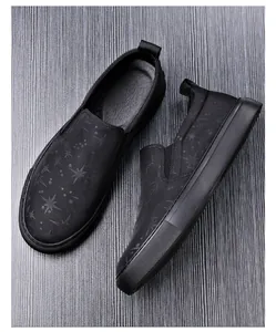 Close-up detail of men's breathable black mesh loafers featuring a subtle star pattern print