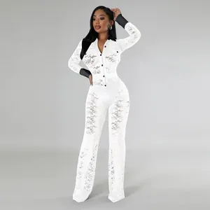 Elegant white lace long sleeve jumpsuit with black contrast collar and cuffs.