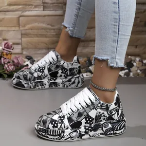 Detailed close-up of women's stylish black and white graffiti print platform sneakers.