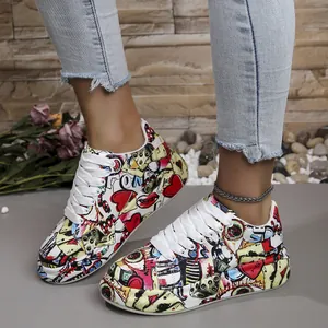 Detail of women's colorful graffiti sneakers with thick white soles and laces