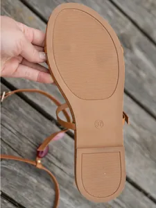 Macro detail of a women's flat sandal sole showing anti-slip pattern and size 37