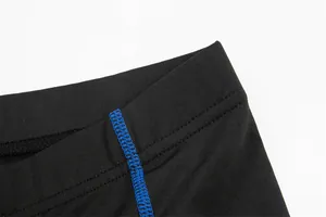 High-quality close-up detail of blue flatlock stitching on black cycling shorts waistband.