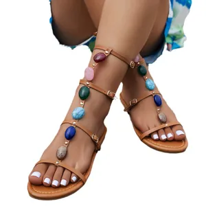 Bohemian flat gladiator sandals with colorful stone embellishments and buckled straps