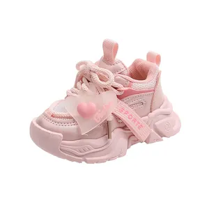 Detail of pink toddler sneakers with mesh upper and heart ornament on the side