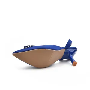 Detailed view of blue satin slingback heels with rhinestone buckle and slim stiletto heel.