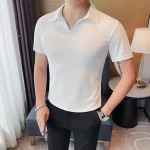 Detail showing the slim-fit silhouette and V-neck collar of this white men's polo shirt.