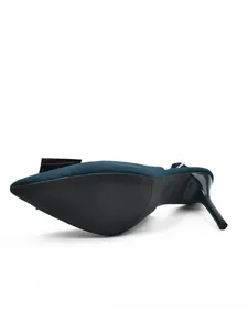 Close-up view showing the sole and stiletto heel of these dark teal pointed toe slingback sandals.