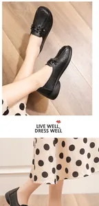 Close-up of black leather loafers with floral laser-cut details and soft sole for women
