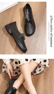 Close-up of black hollow floral leather shoes for middle-aged women on model