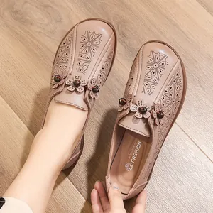 Elegant beige leather hollow-out flat loafers for elderly women featuring floral cutouts