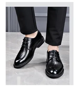 Front view of black leather business dress shoes with elegant perforated brogue detailing