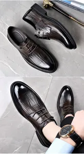 Detailed view of men's brown leather dress shoes featuring elegant perforated patterns.