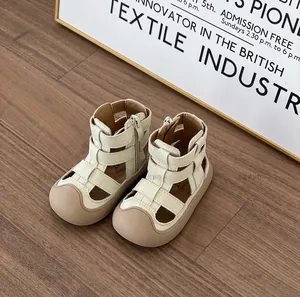 Close-up of toddler cream Roman sandals showing side zipper and soft textured upper.