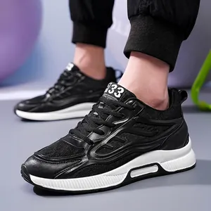 Breathable black fly-knit mesh athletic sneakers for men with durable white soles