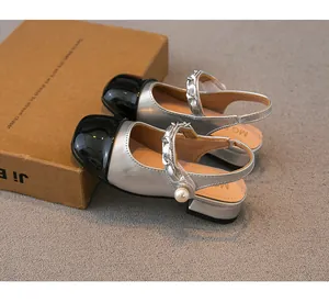 Side view detail of silver girls' sandals with pearl chain and black toe cap