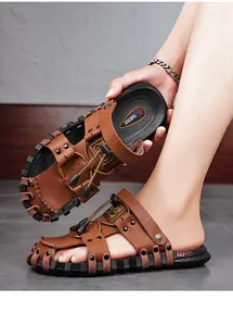 Detail view of brown leather men's sandals with non-slip rubber soles and drawstring