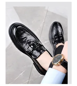 Detail view of breathable black leather loafers for men featuring stylish hollow-out pattern
