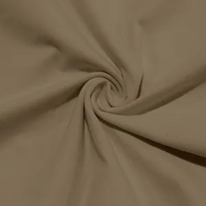 Macro close-up view showing the soft beige fabric texture of a men's solid high-neck t-shirt