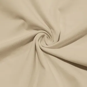 Macro view of soft cream knit fabric texture for men's high-neck slim fit T-shirt
