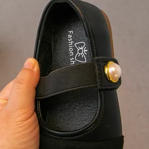 Elegant black girls Mary Jane shoes featuring a pearl strap and flexible elastic band detail