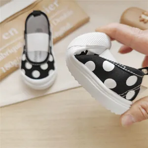 Detailed close-up view showing the extremely flexible soft sole of polka dot children's canvas shoes