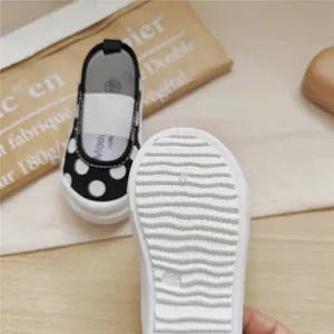 Detailed view showing the flexible non-slip sole of polka dot toddler walking shoes