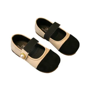 Elegant beige and black girls' Mary Jane flats with pearl detail and comfortable sole