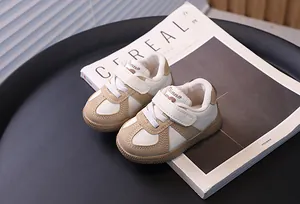 Detail of toddler cream walking sneakers with hook and loop closure on a tray