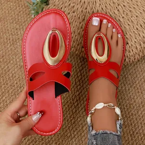 Red flat sandals for women featuring stylish gold metal hardware and shell anklet