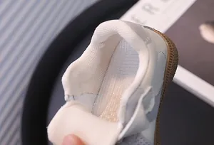 Detail showing the breathable mesh lining and soft collar of children's sneakers