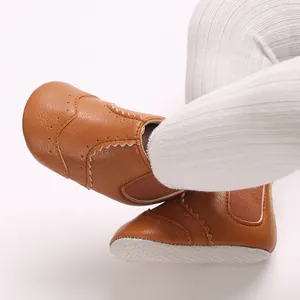 Detail van bruine kunstlederen baby loopschoenen met zachte en veilige antislipzool.