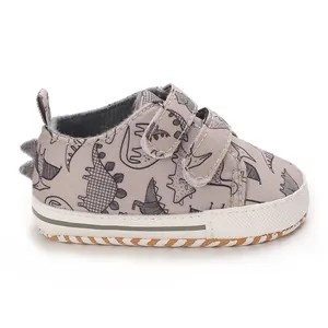 Adorable grey dinosaur print baby sneakers with non-slip soles and velcro straps for infants
