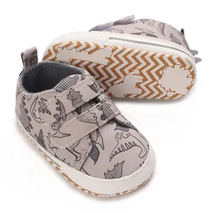 Detailed close-up of infant sneakers with cartoon dinosaur patterns and non-slip soles