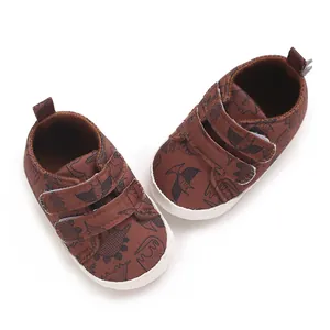 Detail showing the cute cartoon dinosaur patterns and secure Velcro strap closure.