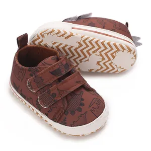 Detail view of brown baby dinosaur print sports shoes with Velcro straps.