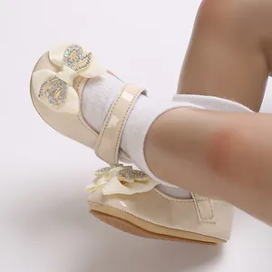 Detail view of beige baby girl princess walking shoes with rhinestone bow decoration