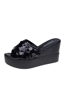 Side view of elegant black sequin platform wedge sandals with fashion insole detail